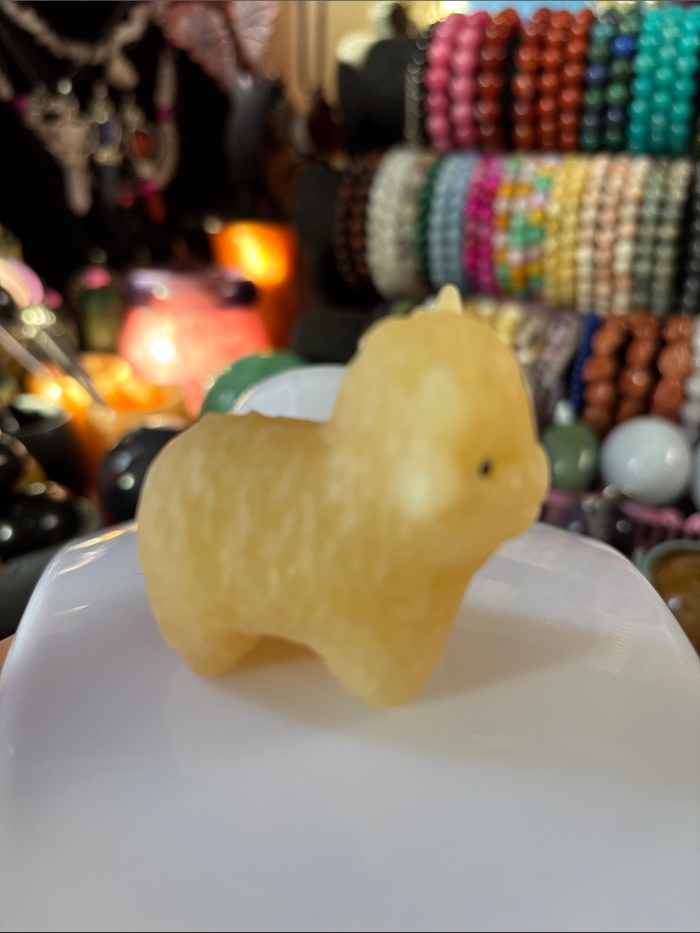 Highland cow figurine made from yellow or orange calcite crystal